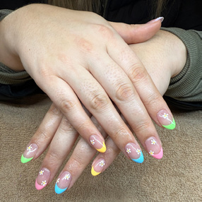 Hands showing off colorful nail treatment