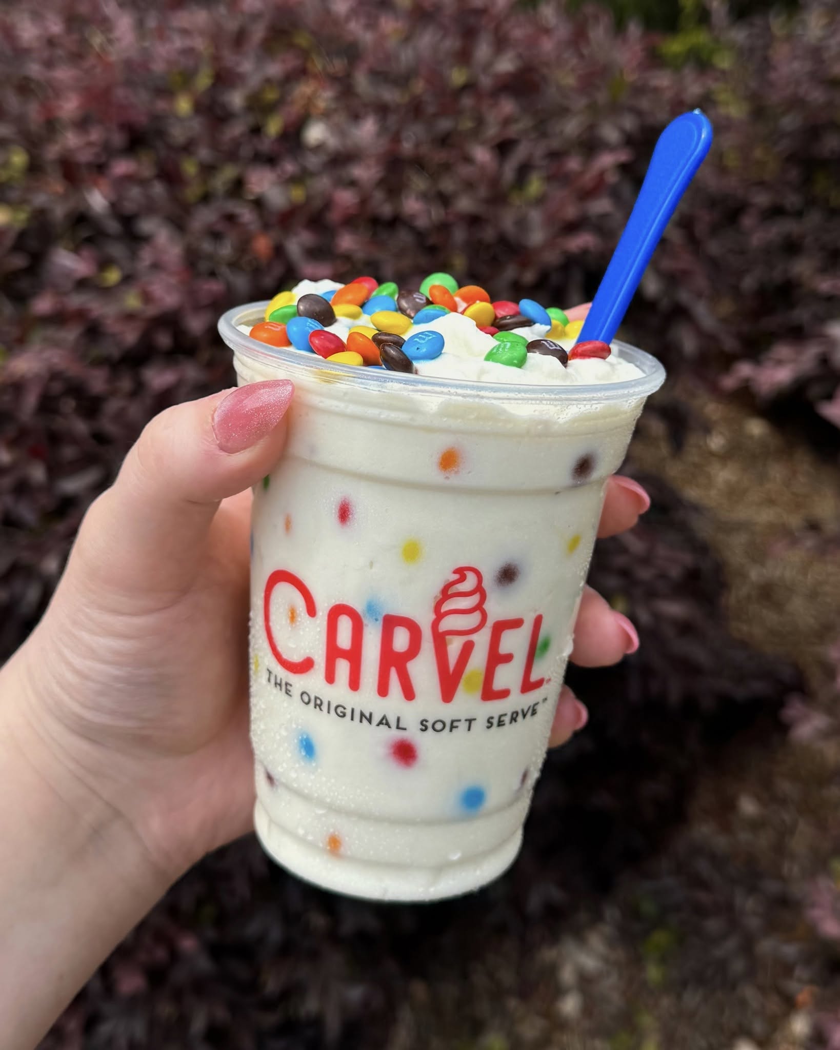 hand holding an ice cream shake from carvel